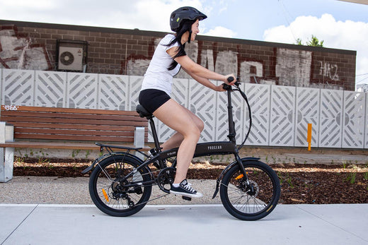 Cyclist on an e-bike commuting through the city